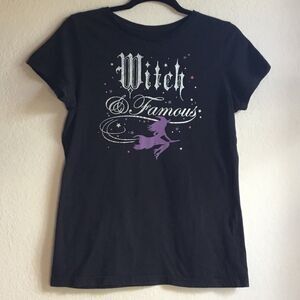 Witch and Famous witchy black tshirt witch on a broom stars gothic font